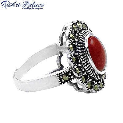 A beautifully crafted silver ring featuring a vibrant red onyx stone surrounded by intricate marcasite detailing, showcasing elegance and craftsmanship.