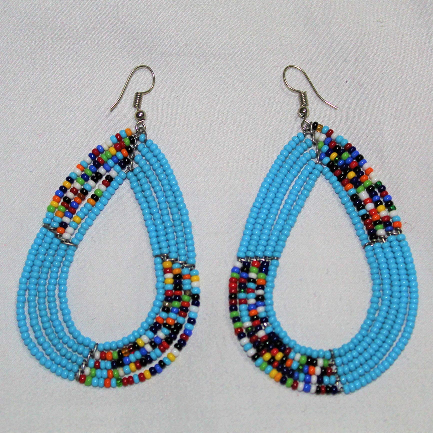 Maasai Beaded Earrings featuring vibrant blue African seed beads in an oval shape, handcrafted for a unique style.