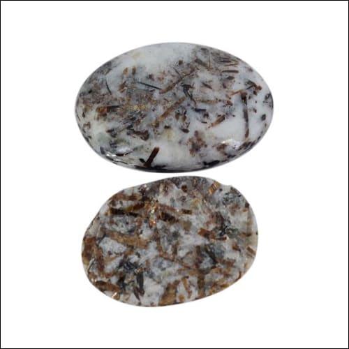 Natural Handmade Astrophyllite Oval Cabochon Gemstone showcasing radiant golden rays and intricate celestial patterns.