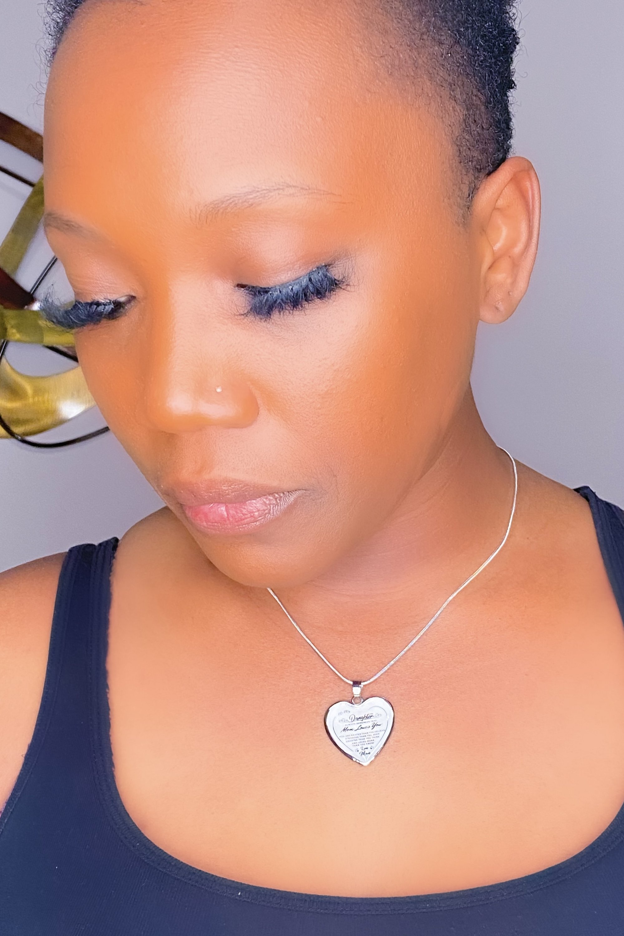 Gold necklace with heartfelt inscriptions for daughters, showcasing a mother's love and appreciation.