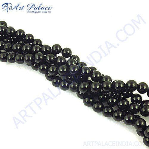 A close-up view of New Fashion Black Onyx Loose Beads showcasing their smooth surface and rich black color, perfect for jewelry making.