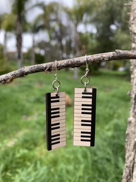 A pair of lightweight wood earrings shaped like piano keys, featuring a natural wood back and silver-finished hypoallergenic ear wires.