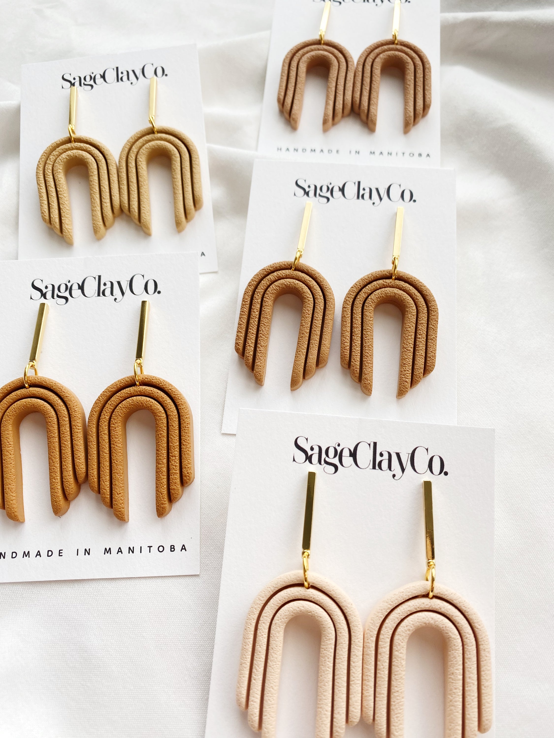 Handmade polymer clay earrings from the Desert Sands Collection, featuring unique designs and hypoallergenic posts.