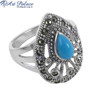 A stunning silver ring featuring pyrite and synthetic turquoise gemstones, adorned with marcasite accents, showcasing intricate craftsmanship.