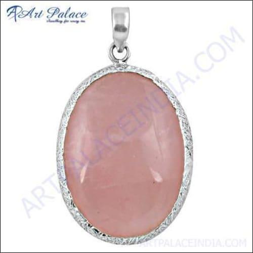 Elegant silver pendant featuring a large rose quartz gemstone, showcasing its soft pink color and intricate design.