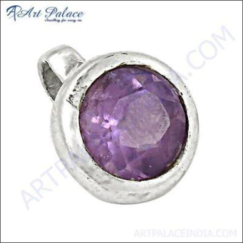 A shiny round amethyst gemstone set in a sterling silver pendant, showcasing its deep purple hue and elegant design.