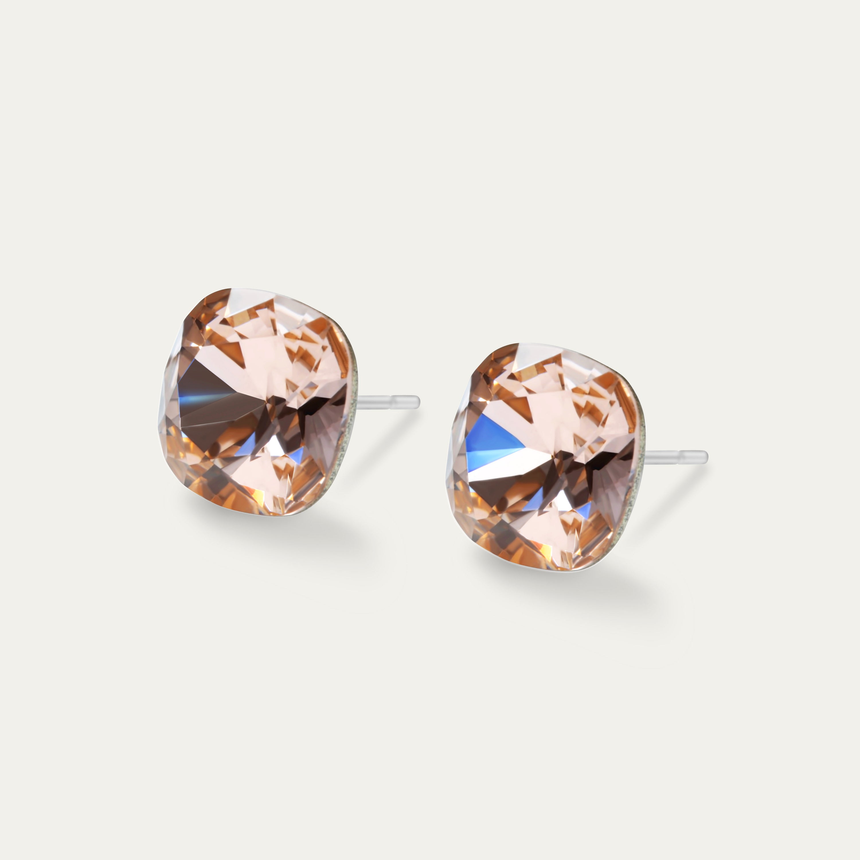 Sophia Light Peach 10mm Crystal Cushion Earrings on a soft background, showcasing their elegant design and peach color.