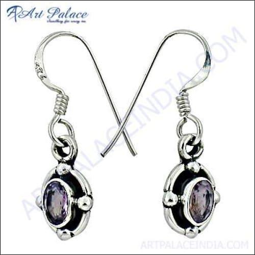 A pair of stunning silver earrings featuring vibrant amethyst gemstones, showcasing intricate design and craftsmanship.