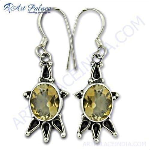 A pair of stunning silver earrings featuring vibrant citrine gemstones, showcasing intricate craftsmanship and elegant design.