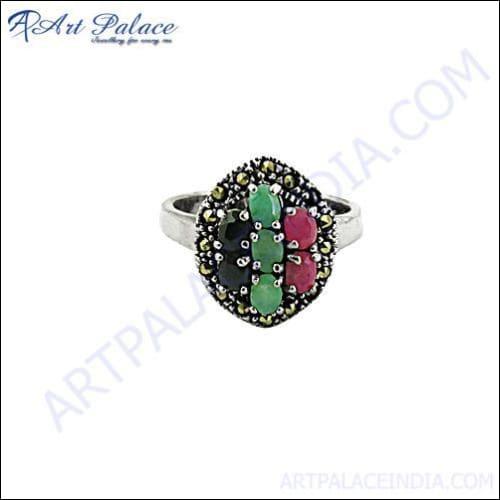 A collection of stunning emerald, ruby, sapphire, gun metal, and silver rings displayed elegantly, showcasing intricate designs and vibrant gemstones.
