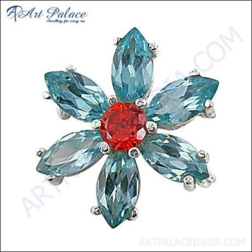 A stunning flower brooch featuring blue topaz and red cubic zirconia gemstones, handcrafted by Art Palace, Jaipur.