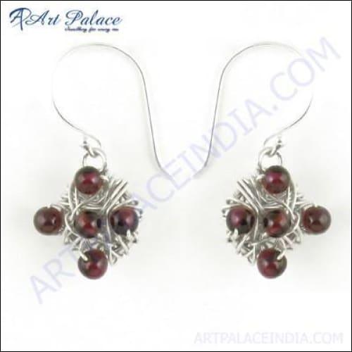 A pair of stunning garnet gemstone earrings set in 925 silver, showcasing intricate design and vibrant color.