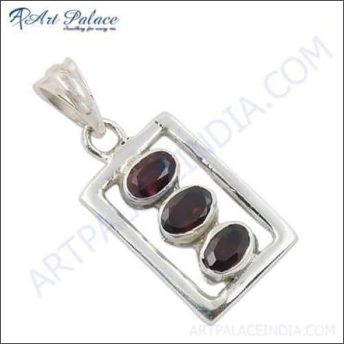 A stunning silver pendant featuring a deep red garnet gemstone, elegantly designed for versatile wear.