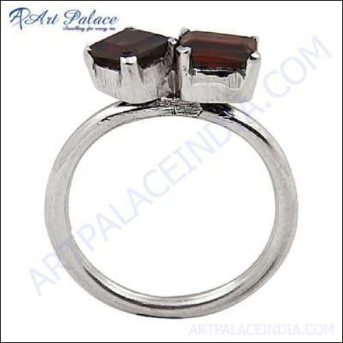 A stunning silver ring featuring a deep red garnet gemstone, showcasing intricate craftsmanship and elegant design.