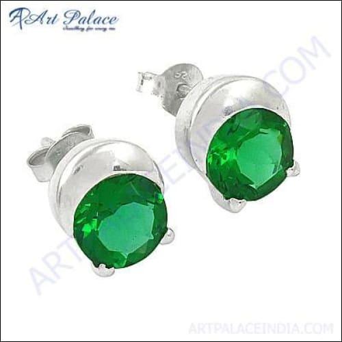 A pair of stunning silver earrings featuring green cubic zirconia gemstones, showcasing intricate design and craftsmanship.