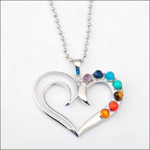 Stunning heart-shaped pendant made of 925 silver, adorned with colorful multi-gemstones, showcasing intricate craftsmanship.