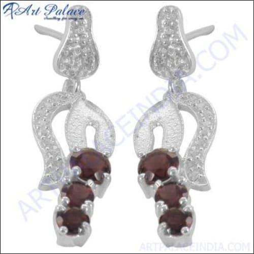 A pair of stunning Indian silver earrings featuring sparkling cubic zirconia stones, showcasing intricate design and craftsmanship.