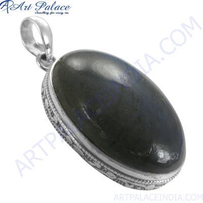 A stunning oval labradorite silver pendant showcasing intricate silver detailing and the mesmerizing colors of the labradorite gemstone.