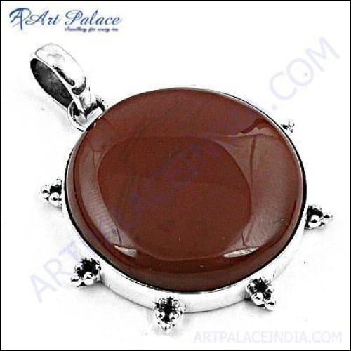 A stunning large red onyx gemstone set in a beautifully crafted silver pendant, showcasing intricate design and vibrant color.
