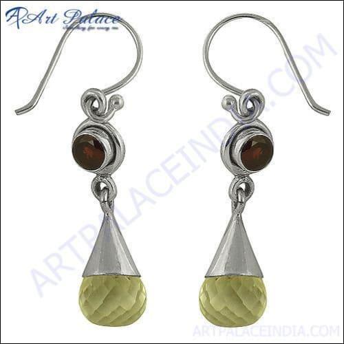 Long silver earrings featuring beautiful garnet crystals, showcasing elegance and style.