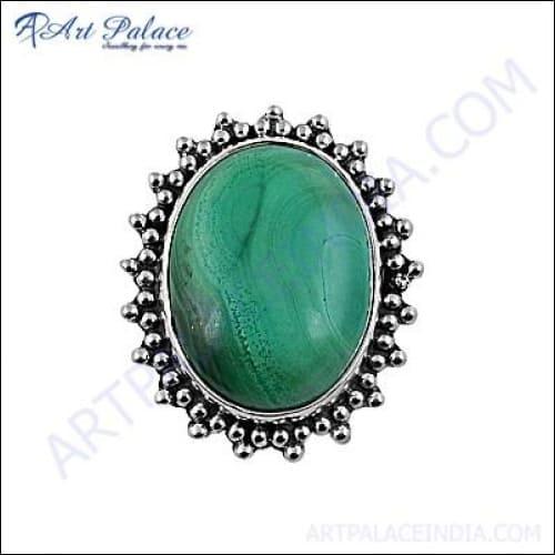 A stunning silver brooch featuring a deep green malachite gemstone, showcasing intricate craftsmanship and elegant design.
