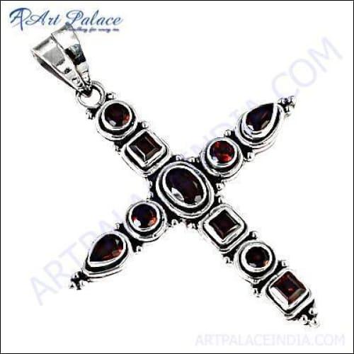 Stunning red garnet cross pendant set in silver, showcasing intricate craftsmanship and vibrant gemstone.