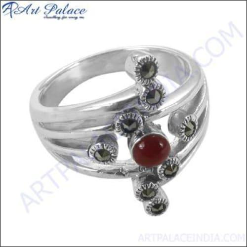 A stunning silver ring featuring a vibrant red onyx gemstone and sparkling pyrite accents, showcasing unique craftsmanship.