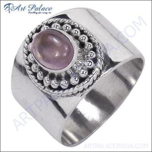 A stunning silver ring featuring a large, polished rose quartz gemstone, elegantly designed for a sophisticated look.