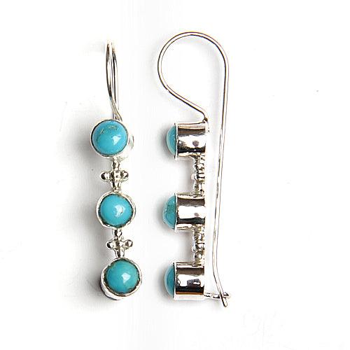 A pair of stunning round cabochon turquoise gemstone earrings, showcasing vibrant blue hues and intricate craftsmanship, perfect for any occasion.