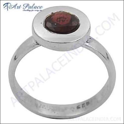 Stunning round cut garnet gemstone set in a 925 sterling silver ring, showcasing its vibrant red color and elegant design.