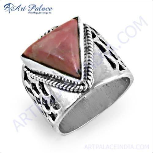 A stunning silver ring featuring a vibrant ruby gemstone at the center, surrounded by intricate fretwork design, showcasing exquisite craftsmanship.
