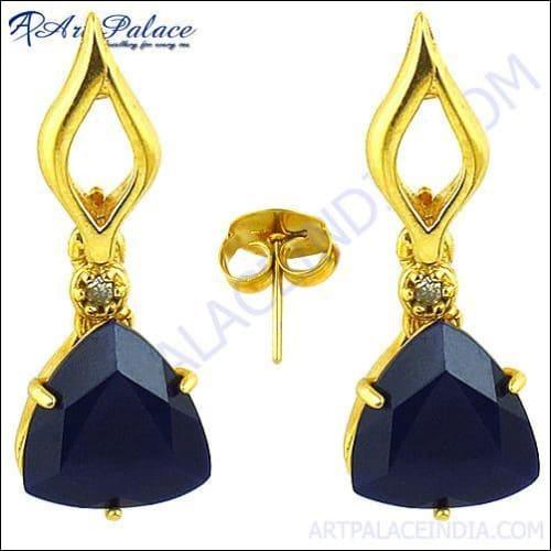 A pair of stunning brass earrings featuring sapphire cubic zirconia stones, elegantly designed for a sophisticated look.