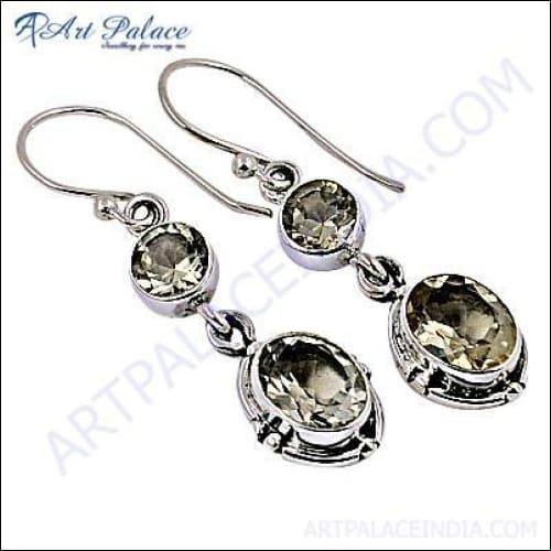 A pair of stunning silver designer earrings featuring vibrant citrine gemstones, showcasing intricate craftsmanship and elegant design.