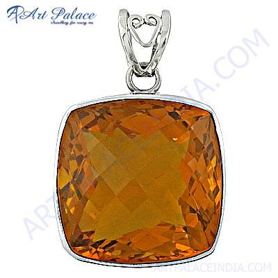 A stunning silver pendant featuring yellow glass and a precious gemstone, showcasing intricate craftsmanship and elegant design.