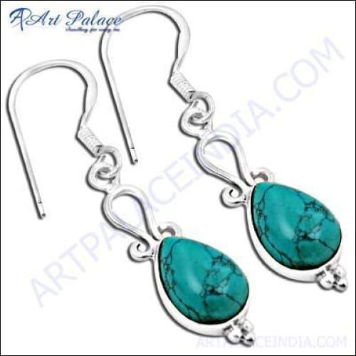 A pair of stunning long earrings featuring synthetic turquoise stones set in high-quality silver, showcasing intricate design and craftsmanship.