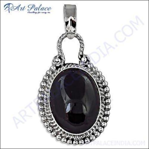 A stunning silver pendant featuring a vibrant tourmaline gemstone, showcasing intricate craftsmanship and elegant design.