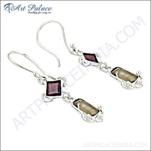Stylish silver earrings featuring vibrant citrine and garnet gemstones, showcasing intricate design and craftsmanship.