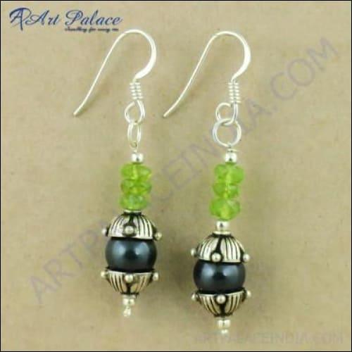 Trendy black pearl and peridot gemstone designer silver earrings, showcasing elegant design and vibrant colors.