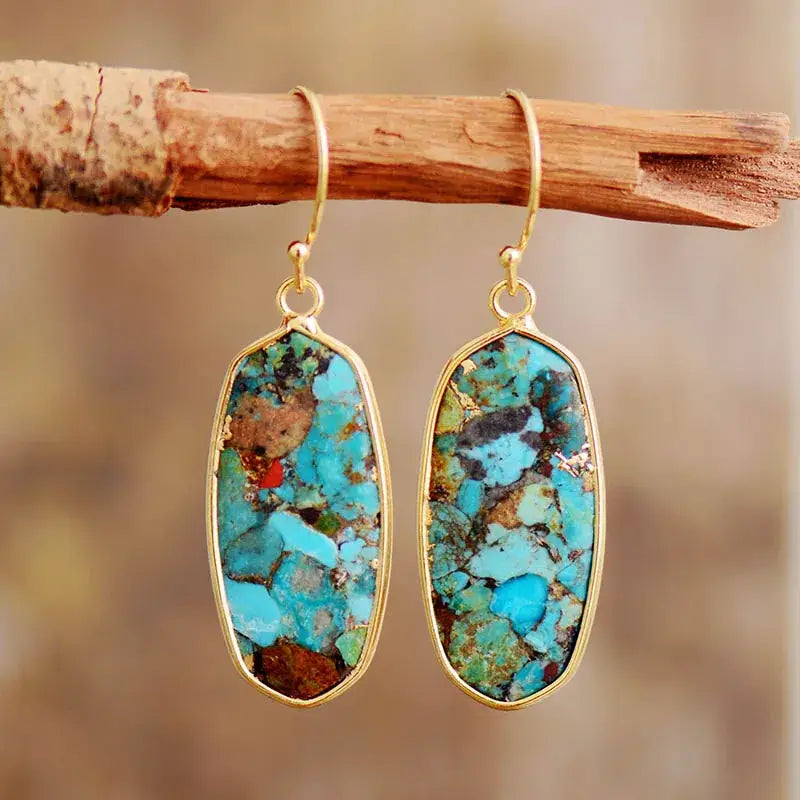 A pair of elegant handmade earrings featuring vibrant turquoise stones, perfect for any occasion.