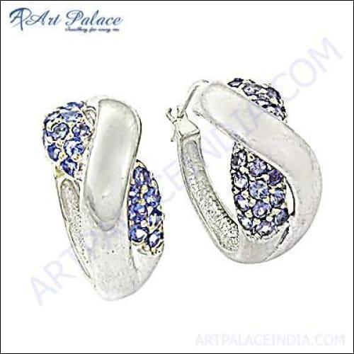 A pair of elegant silver earrings featuring unique blue cubic zirconia gemstones, showcasing intricate craftsmanship and stylish design.