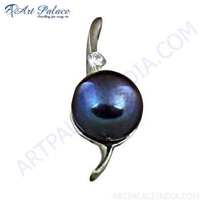 A stunning silver pendant featuring a unique design with a Mabe pearl centerpiece and sparkling cubic zirconia accents.