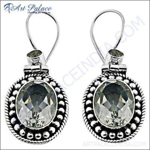A pair of unique designer silver earrings adorned with sparkling crystals, showcasing intricate craftsmanship and elegant design.