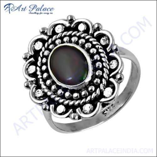 A collection of unique feminine designer silver rings featuring opal gemstones, showcasing vibrant colors and intricate designs.
