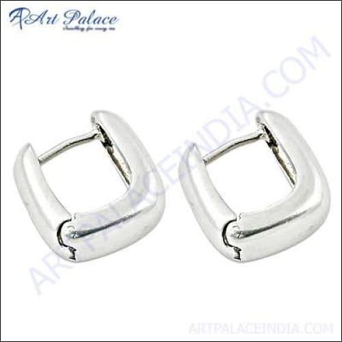 A pair of unique handcrafted sterling silver earrings with intricate designs, showcasing their elegant shine and craftsmanship.