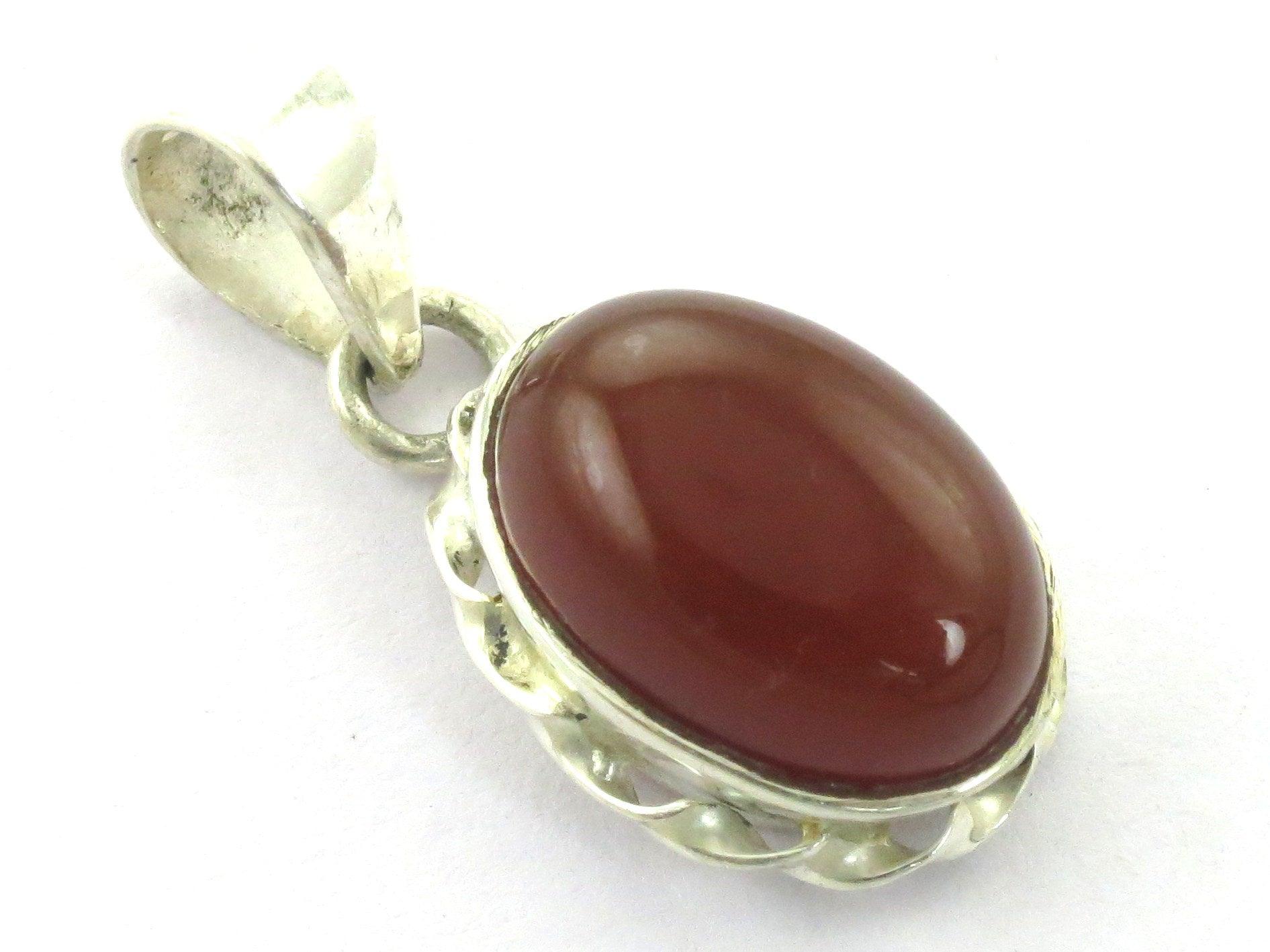 A stunning 925 sterling silver pendant featuring a vibrant red onyx gemstone, showcasing intricate craftsmanship and elegant design.