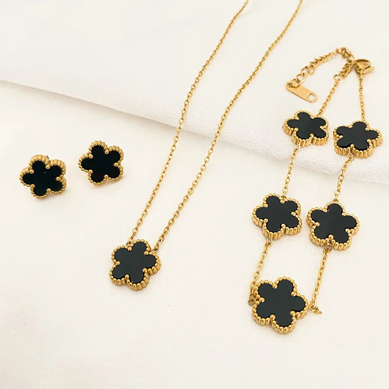 A luxurious 3-piece jewelry set featuring a five leaf flower pendant necklace, earrings, and bracelet made from stainless steel with shell accents.