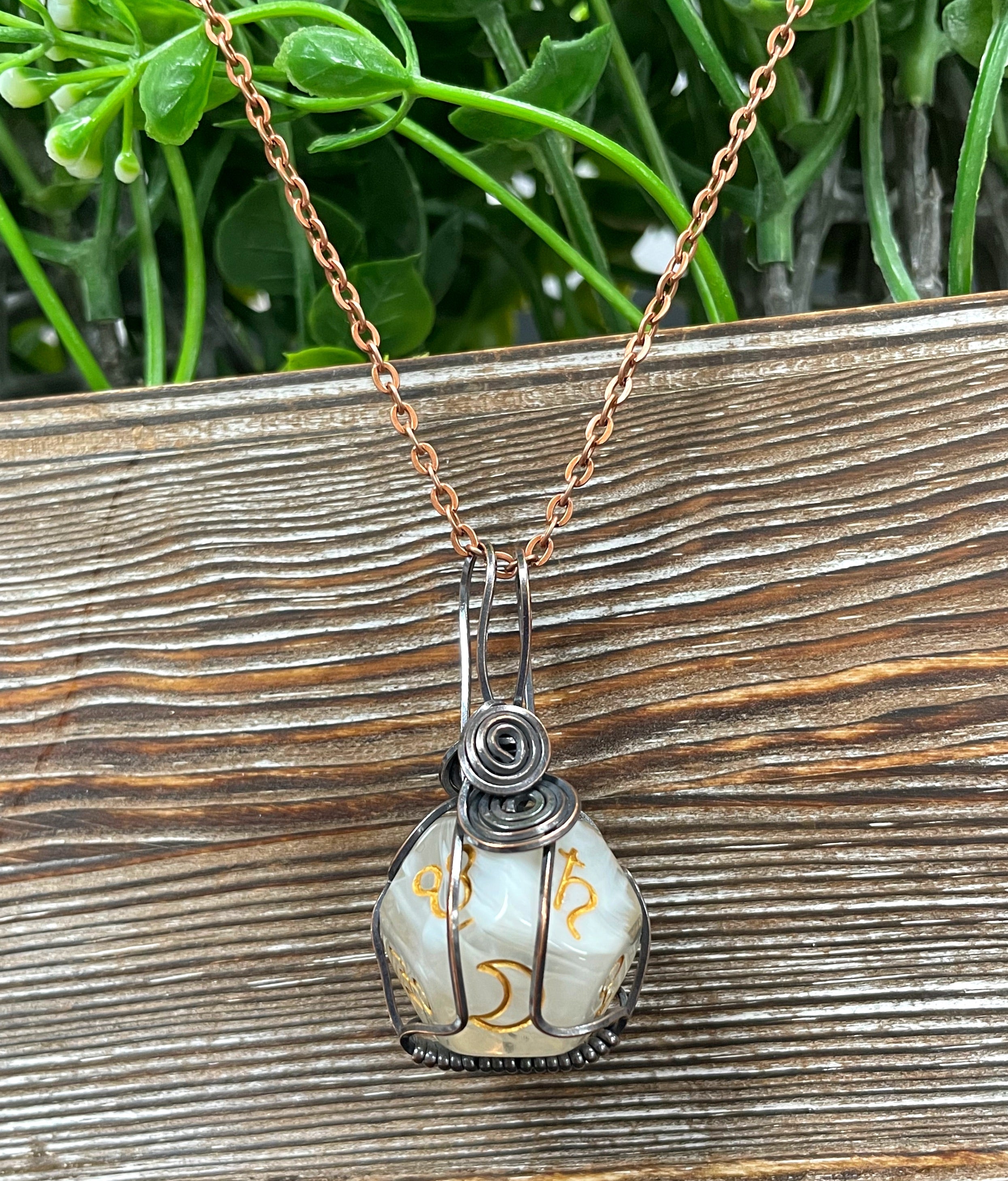 Astrological Random Color Wire Wrapped D12 Dice Pendant on a suede leather cord, showcasing oxidized copper wire wrapping and colorful D12 dice.