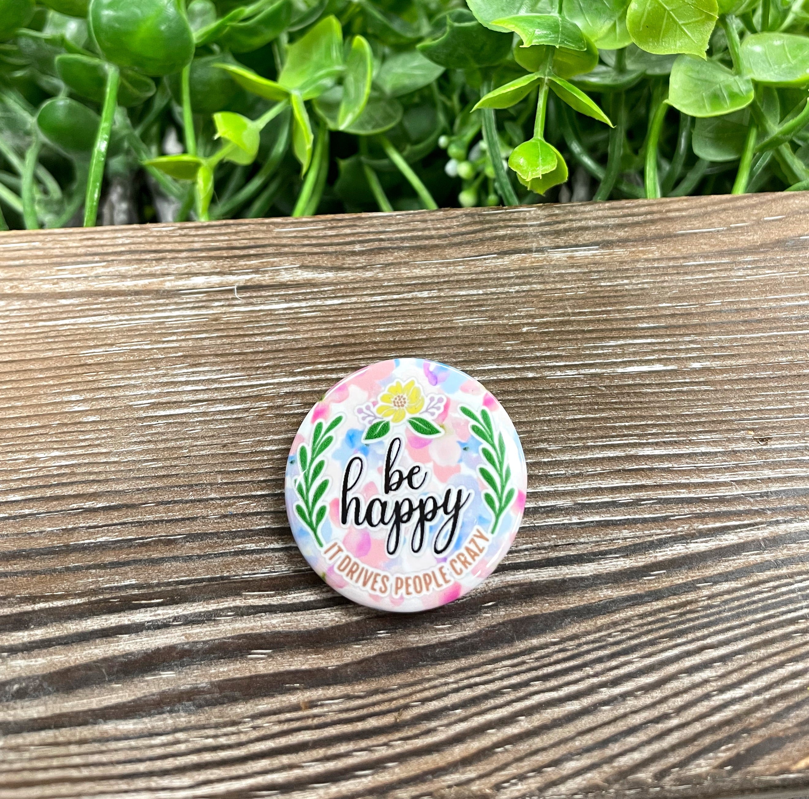 Be Happy Laurel Leaves Graphic Art Button, 1.25 inches, featuring a vibrant design with laurel leaves.