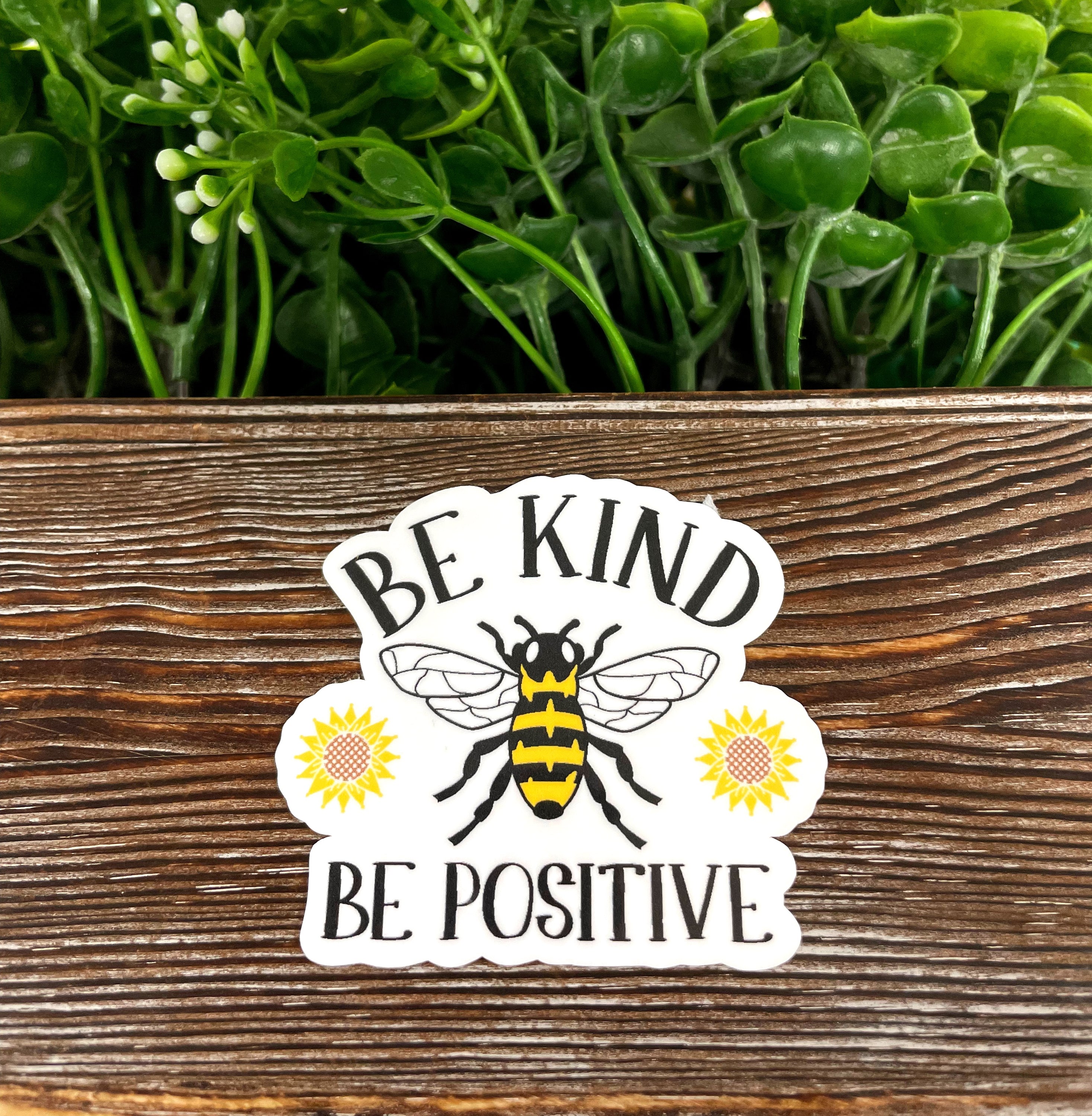 Bee Kind Bee Positive die cut vinyl sticker featuring a vibrant design, perfect for personalizing smooth surfaces.
