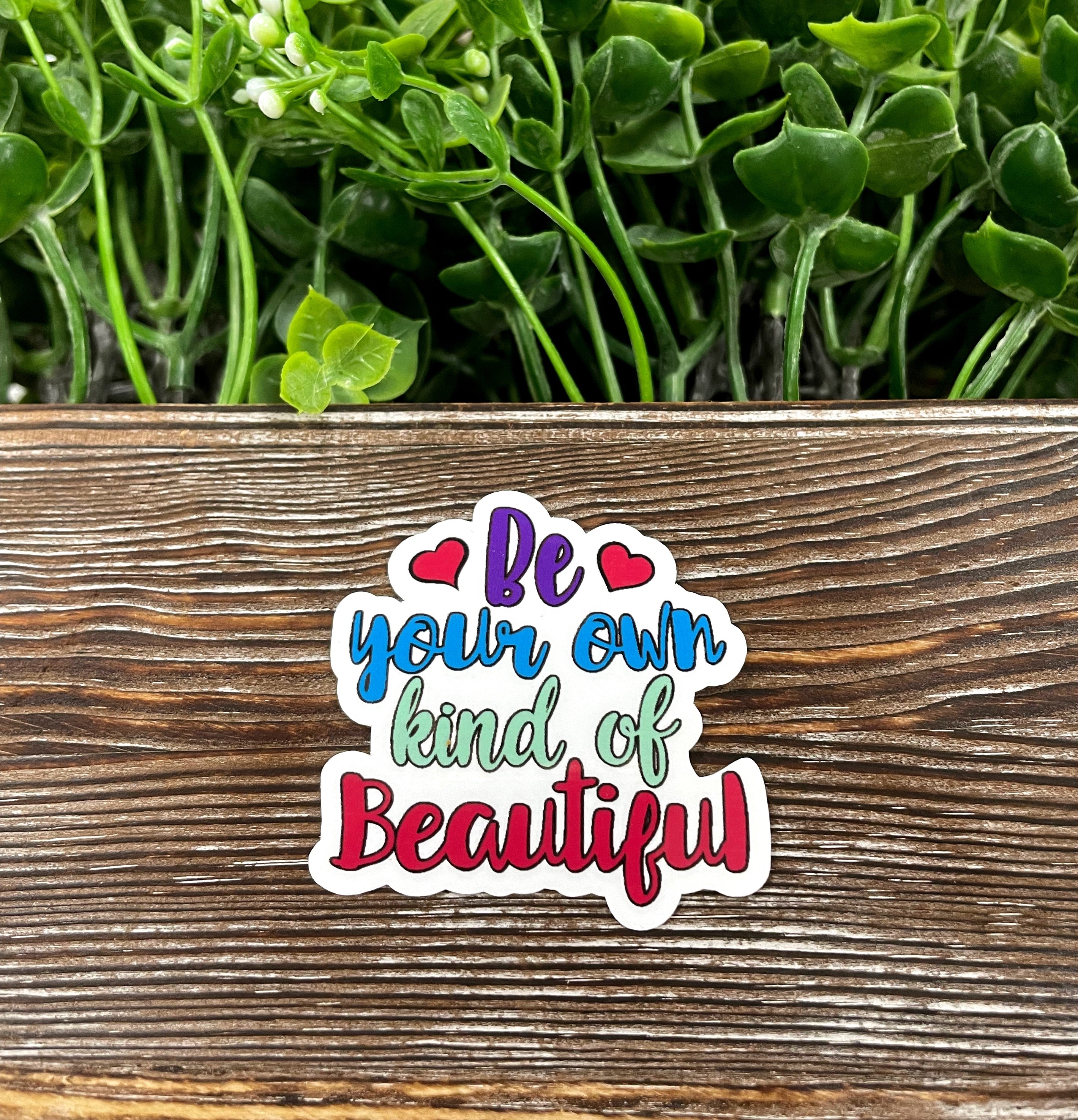 Be Your Own Kind of Beautiful die cut sticker featuring vibrant colors and a unique graphic design, perfect for personalizing items.